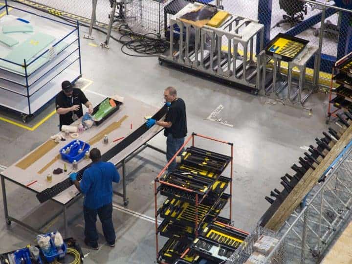 Manufacturing workers make products on a shopfloor.