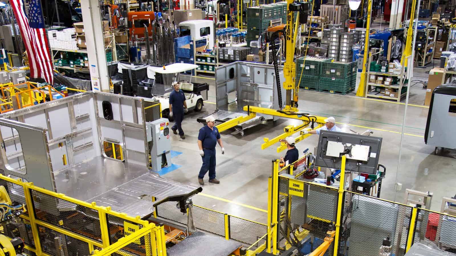Manufacturing workers walk on the shopfloor.