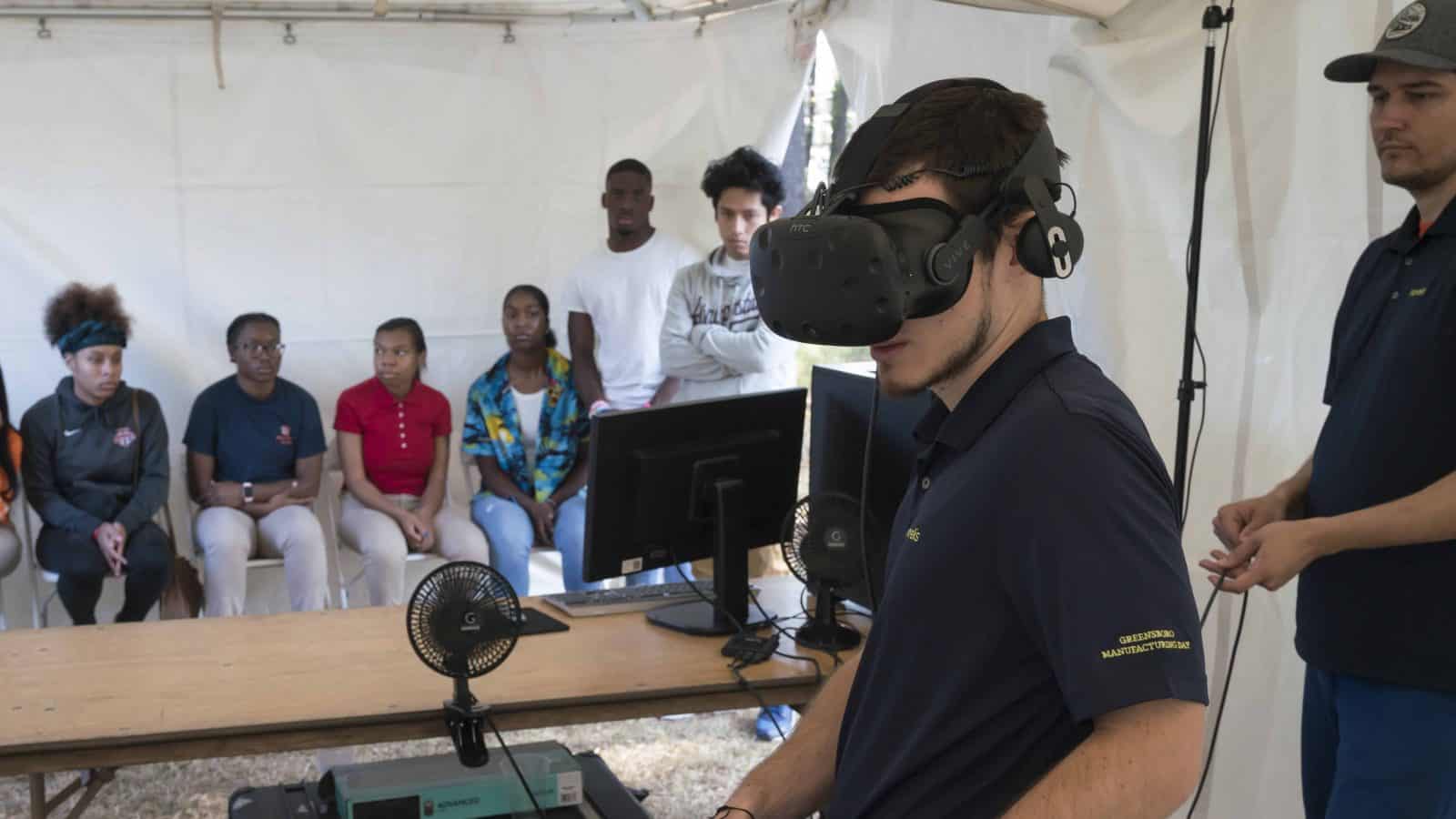 Student wears VR glasses at Novelis' Manufacturing Day event
