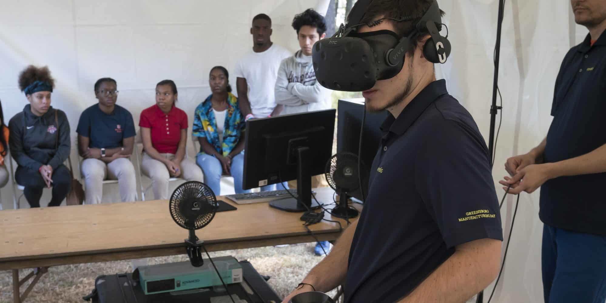 Student wears VR glasses at Novelis' Manufacturing Day event
