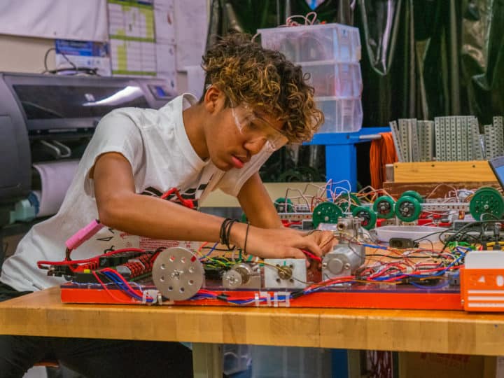 Photo of youth working with electronics